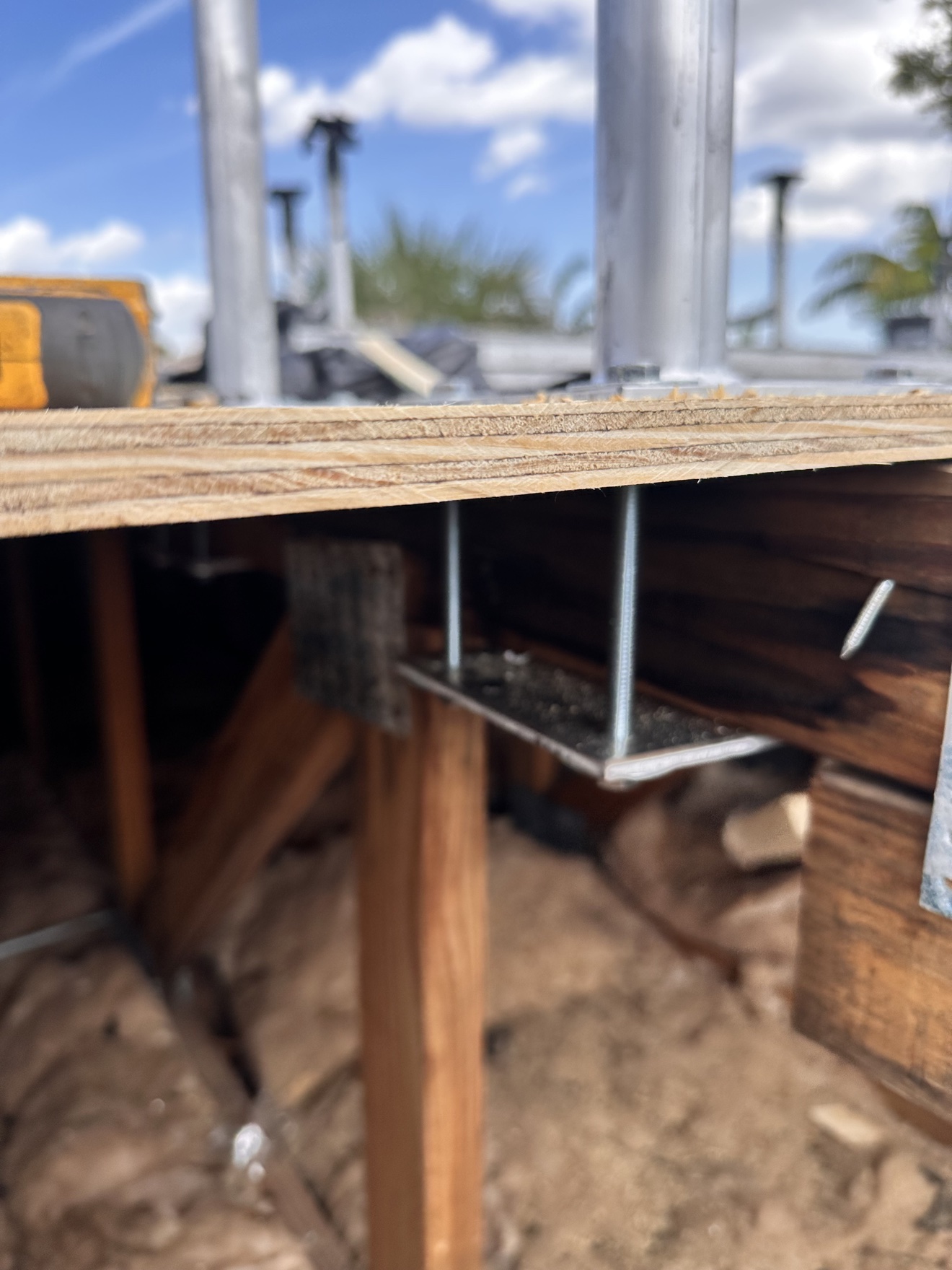 Rotted decking and rusted mounting at a failed condenser stand
